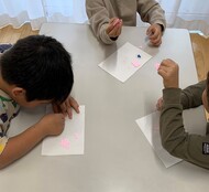 子どもが型抜きしたものを見せ合っている写真